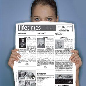 A women holding The Review newspapers notices with obits on it up in front of herself to promote sharing a life stories with obituary notices.
