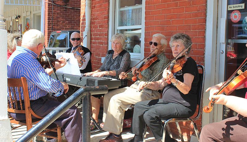 Fiddlers played tunes for passer-bys.