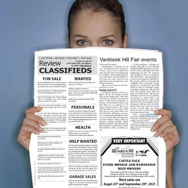 Women peering over the top of The Review newspaper classifieds section of the paper. Inviting people to advertise in classifieds: Connect. Buy. Sell. Rent.