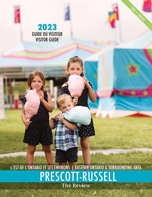 The cover of the 2023 Prescott-Russell Tourism Magazine Publications with a photo of three children eating cotton candy at the fair