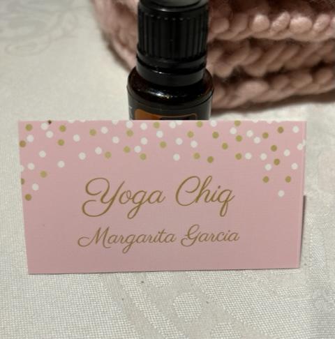 This is a photo of Margarita's business card. It is ink with gold writing that says "Yoga Chiq with Margarita Garcia" and it is being use to help promote Yoga Classes with Margarita Garcia at Zudio