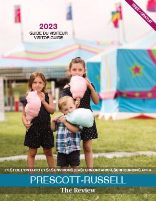 This is the Cover of the 2023 Visitor Guide Magazine with three young children eating cotton candy.